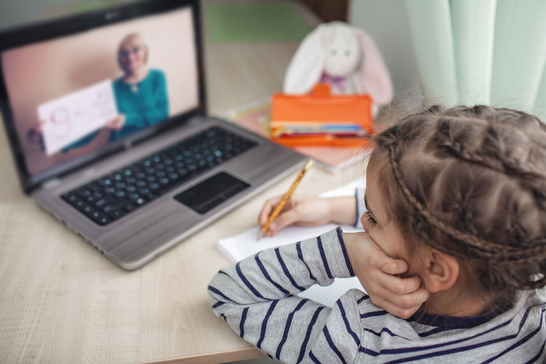 schoolgirl studying math during online lesson at home, self-isolation